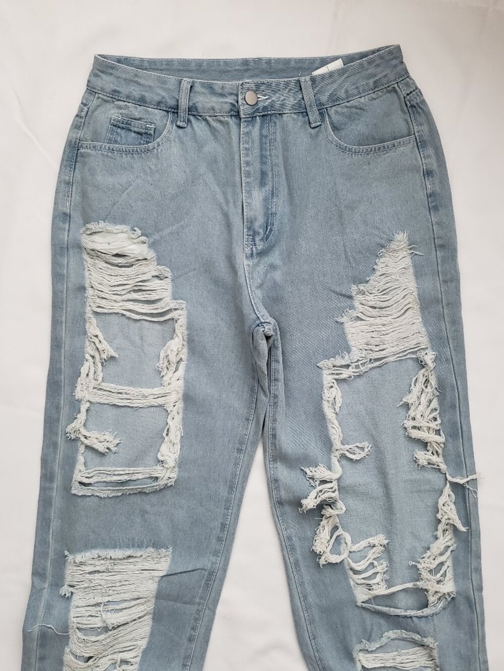 Heavy rip distressed light blue jeans relaxed fit